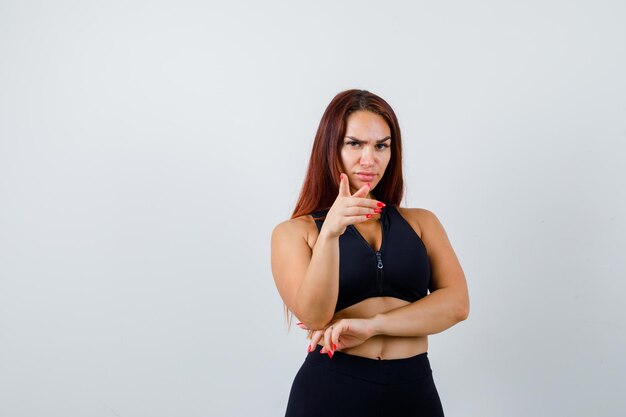 Young sporty woman with long hair in a black top