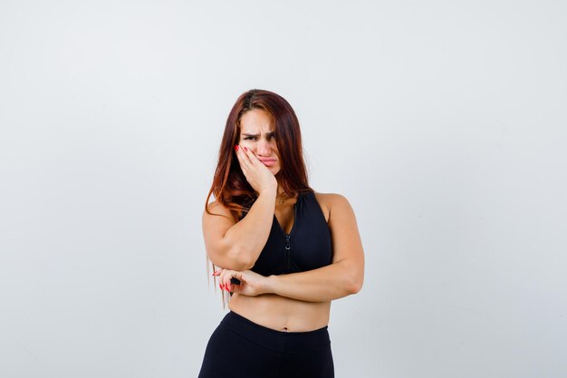 Young sporty woman with long hair in a black top