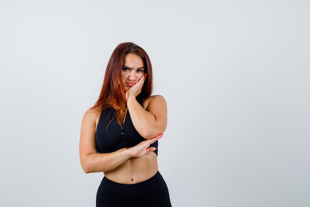 Young sporty woman with long hair in a black top