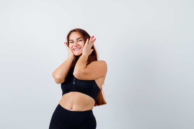 Young sporty woman with long hair in a black top