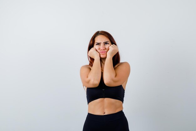 Young sporty woman with long hair in a black top