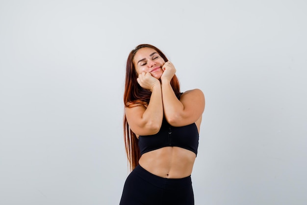 Young sporty woman with long hair in a black top