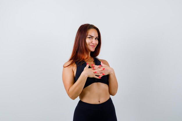 Young sporty woman with long hair in a black top