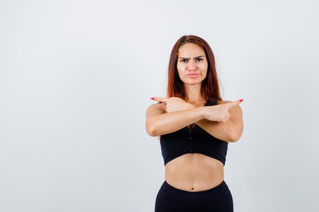 Young sporty woman with long hair in a black top