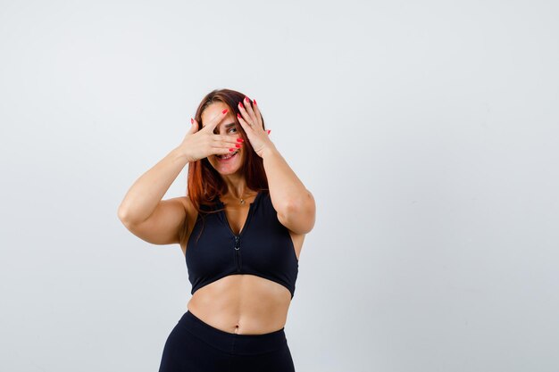 Young sporty woman with long hair covering her face