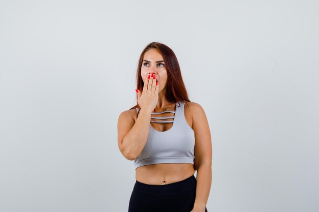 Young sporty woman with long hair in a gray top