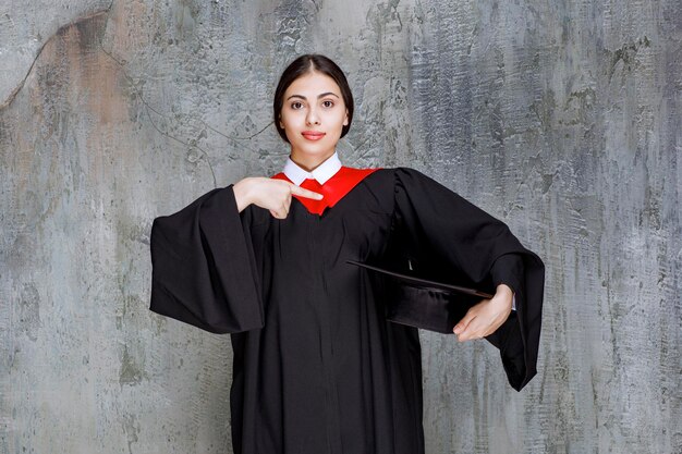 Young student in gown posing for graduation day. High quality photo