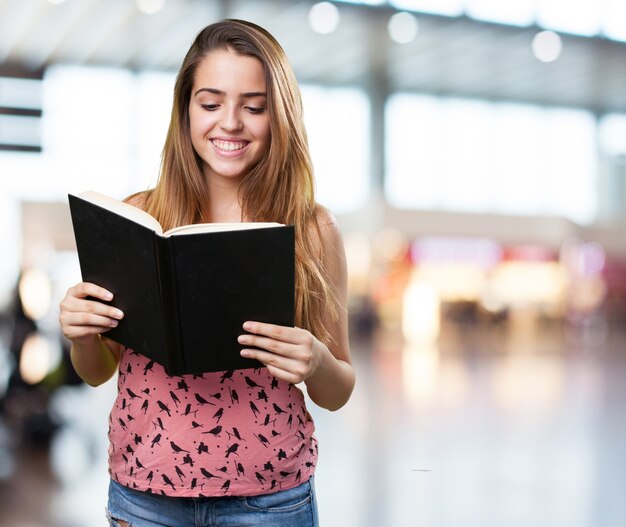 young student reading a book on white background