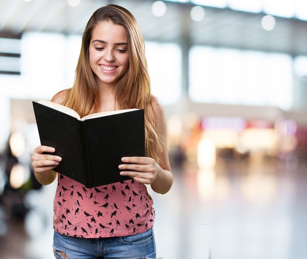 young student reading a book on white background