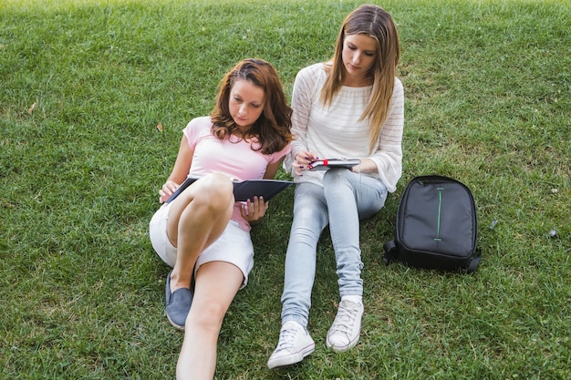 Free photo young students on lawn