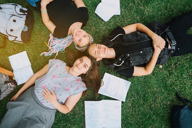 Young students lying on grass