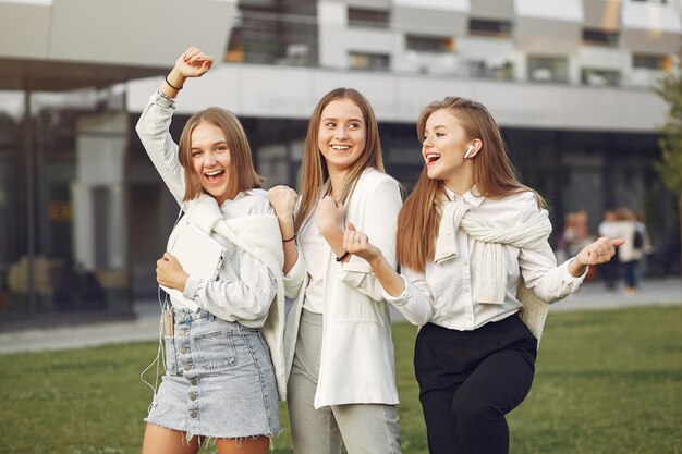 Young students on a student campus with a phone