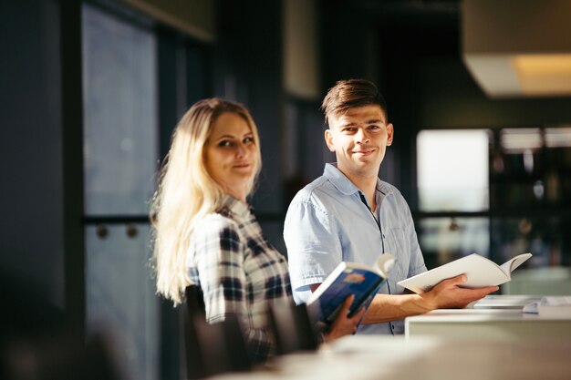 Young studying people in library