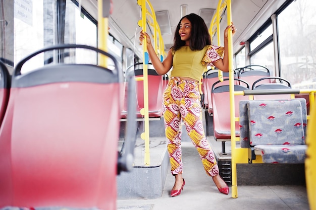 Young stylish african american woman riding on a bus