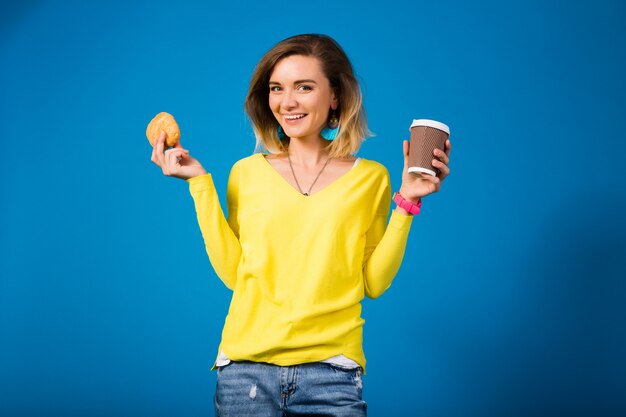 Young stylish attractive woman in yellow blouse on blue