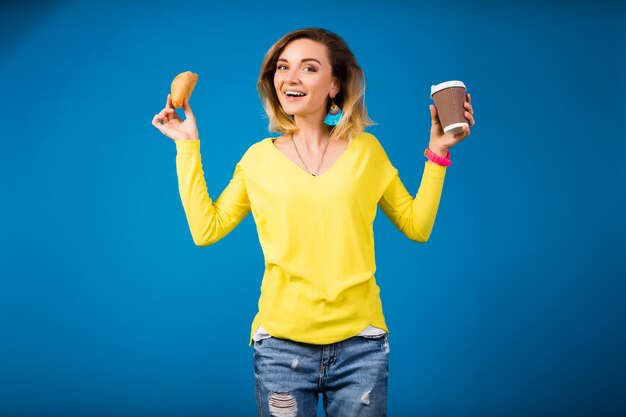 Young stylish attractive woman in yellow blouse on blue