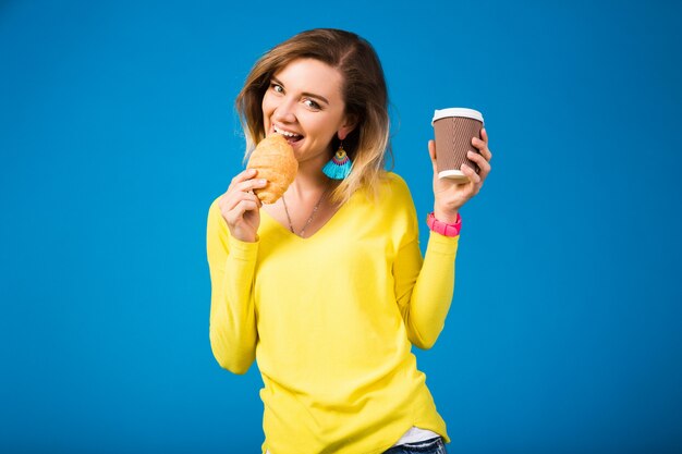 Young stylish attractive woman in yellow blouse on blue