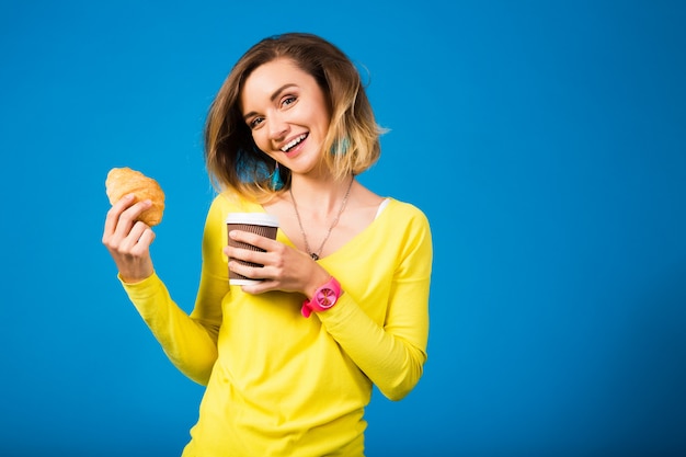 Young stylish attractive woman in yellow blouse on blue