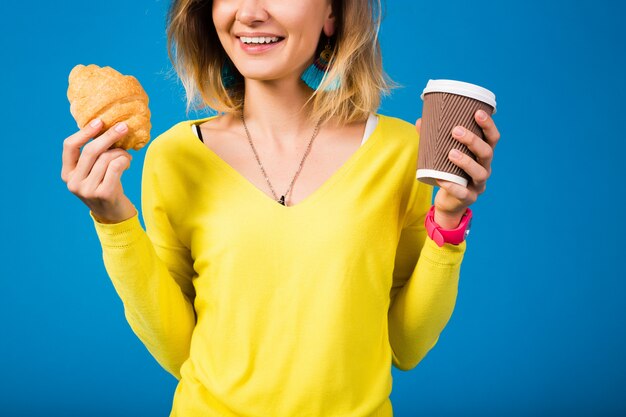 Young stylish attractive woman in yellow blouse on blue