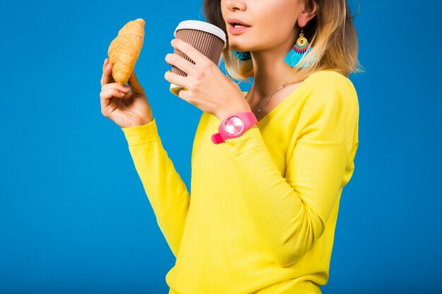 Young stylish attractive woman in yellow blouse on blue