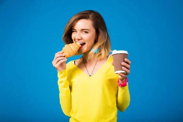 Young stylish attractive woman in yellow blouse on blue