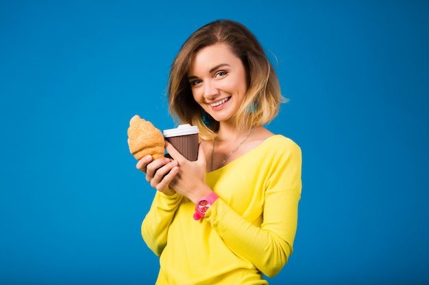 Young stylish attractive woman in yellow blouse on blue