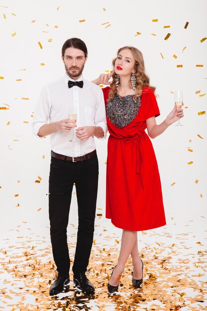 Young stylish couple in love celebrating new year and drinking champagne