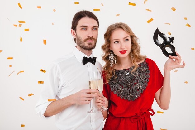 Young stylish couple in love celebrating new year and drinking champagne