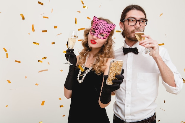 Young stylish couple in love drinking champagne at the party