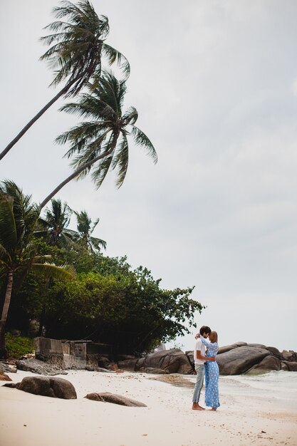 Young stylish hipster couple in love on tropical beach during vacation