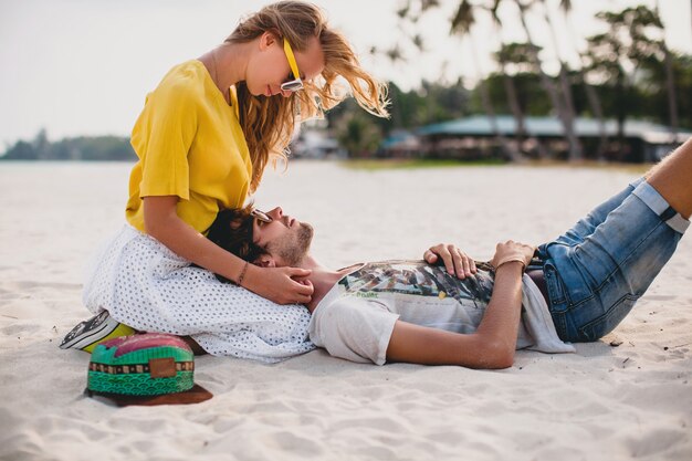 Young stylish hipster couple in love on tropical beach during vacation