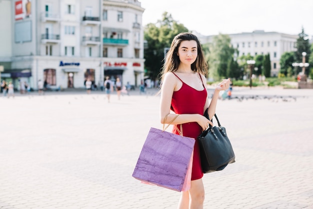 Young stylish model with bags 