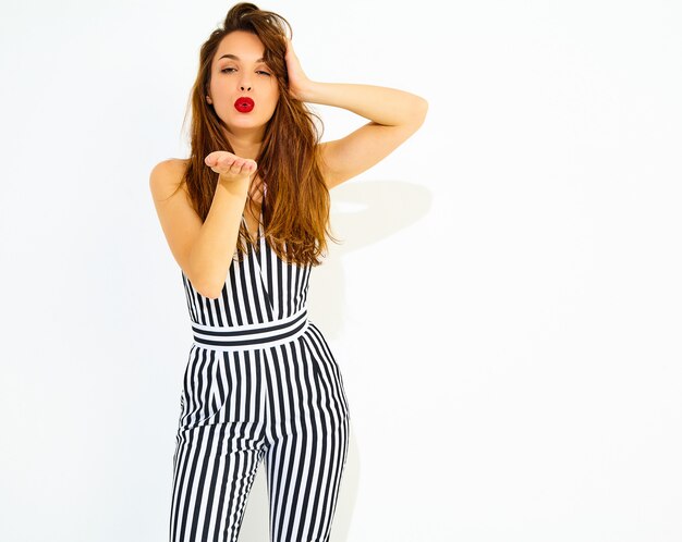 Young stylish smiling woman model in casual summer striped suit with red lips, isolated. GIving air kiss