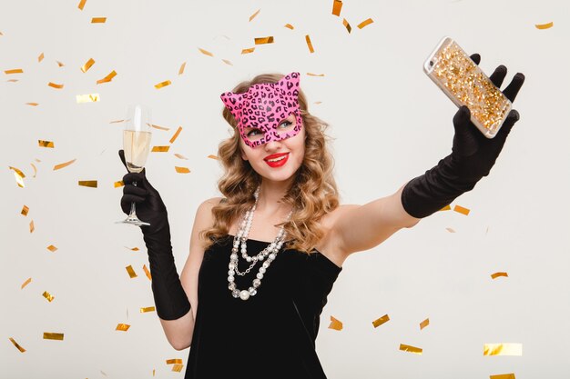 Young stylish woman drinking champagne, making self photo