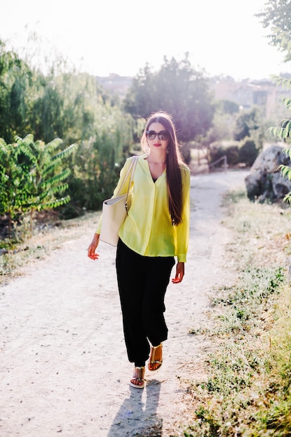 Young stylish woman in park