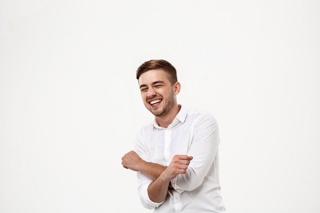 Young successful businessman laughing, rejoicing.