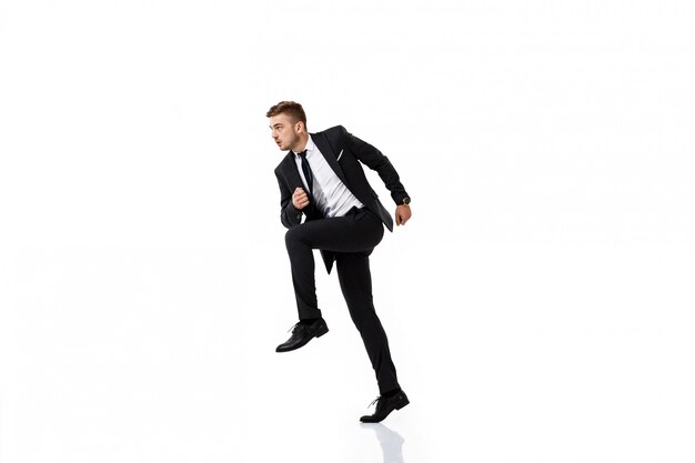 Young successful businessman in suit running.