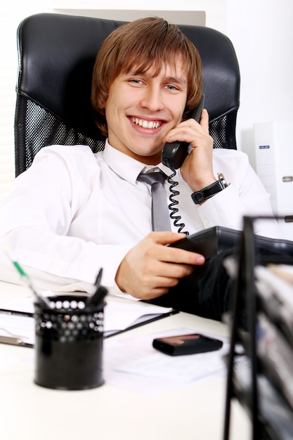 Young and successful businessman talking by phone