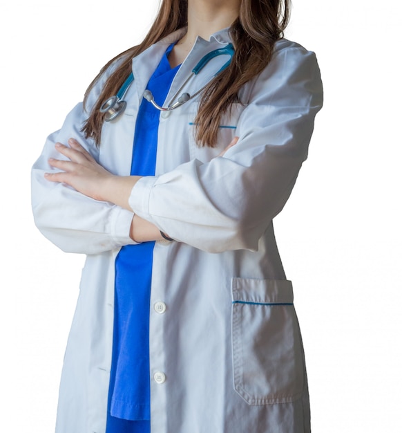 Young successful female doctor in a medical uniform standing confidently with crossed hands