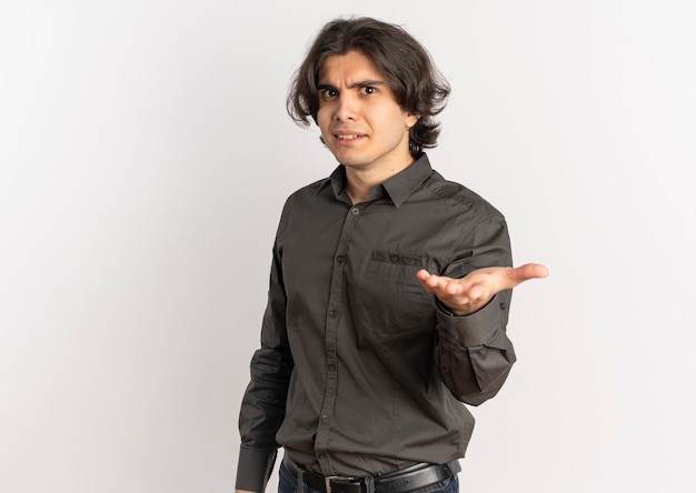 Young surprised handsome caucasian man looks and points at camera isolated on white background with copy space