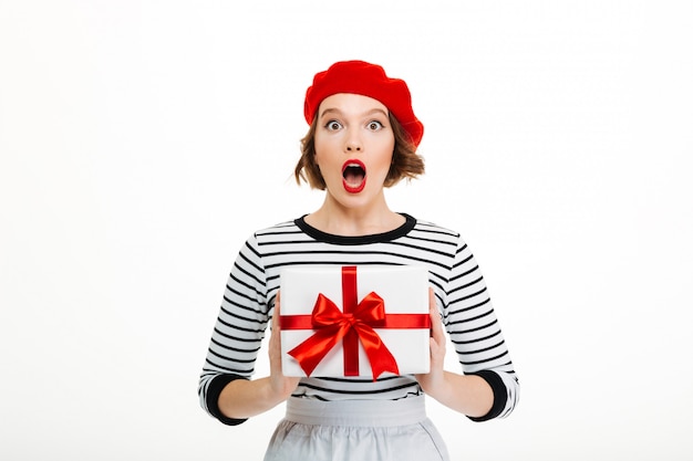 Young surprised lady holding gift surprise box.