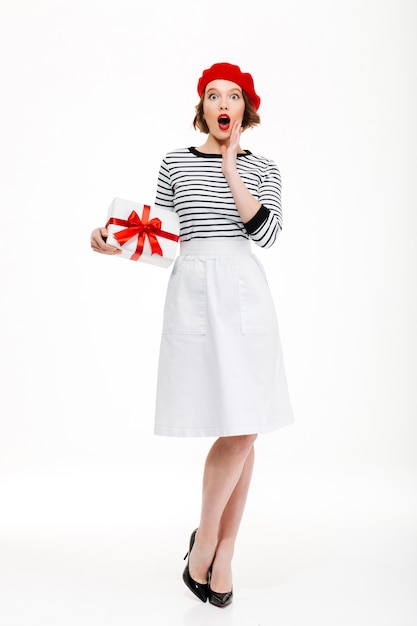 Free photo young surprised lady holding gift surprise box.