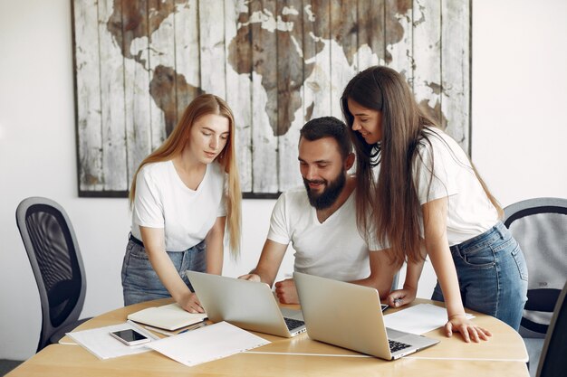 Young team working together and use the laptop