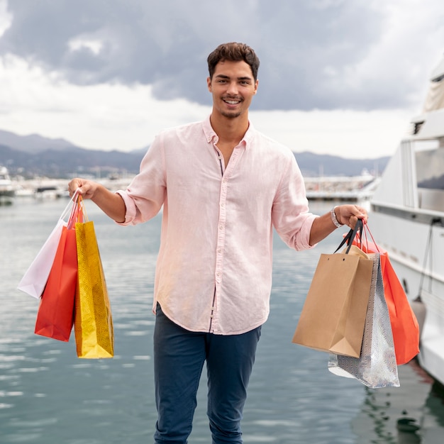 Young teeanger showing his shopping bags