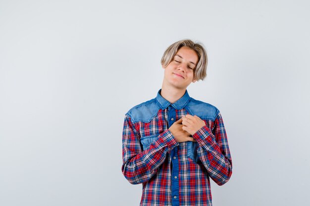 Young teen boy with hands on chest