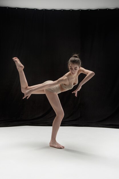 Young teen dancer on white floor