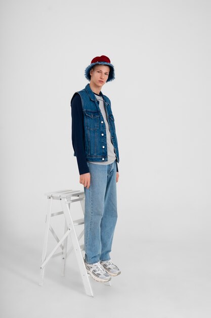 Young teenage boy wearing a denim outfit