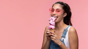 Young teenage girl with sunglasses eating an ice cream