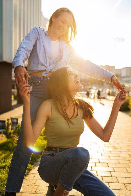 Young teenage girls recording reels of themselves outdoors for social media