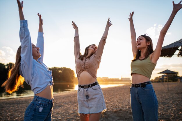 Young teenage girls recording reels of themselves outdoors for social media